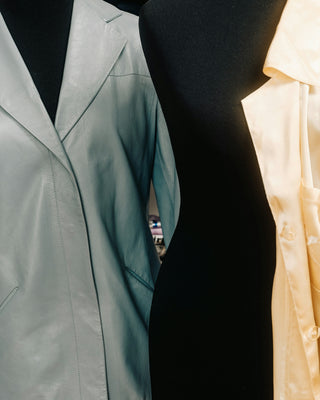 Independent fashion designer with mannequins in a studio