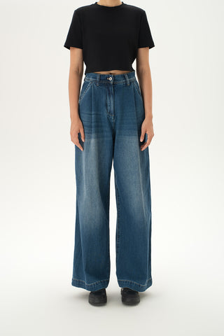 Woman wearing relaxed high-rise baggy jeans with soft pleats and cuffed hems