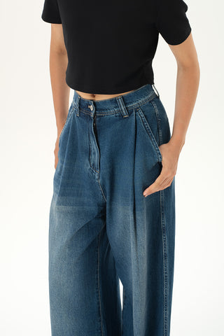 Woman wearing relaxed high-rise baggy jeans with soft pleats and cuffed hems